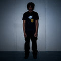 Black graphic tee with graffiti tag print on model – Reflejos Smash & Grab